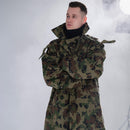 Man wearing a genuine Romanian Army M93 combat camo leaf parka jacket with hood and adjustable fit.