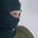 Close-up of a person wearing a gray Swiss Army knitted balaclava covering head and neck for cold weather protection