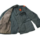 Swiss military surplus wool jacket in grey with red insignia patches and buttoned chest and side pockets