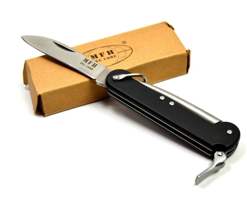 BW German army mariner knife with marlinspike, black handle, stainless steel blade, and cardboard box background