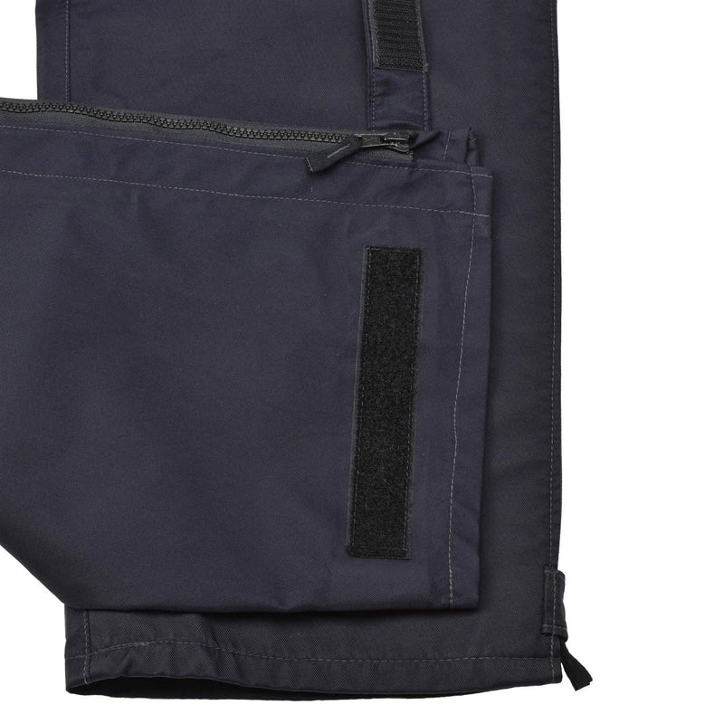 Close-up of blue Genuine British Police waterproof rain trousers with zipper and Velcro fastening details.