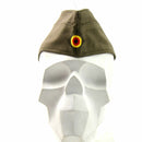 Genuine German army olive green side cap with traditional peak and national insignia on front displayed on white mannequin head