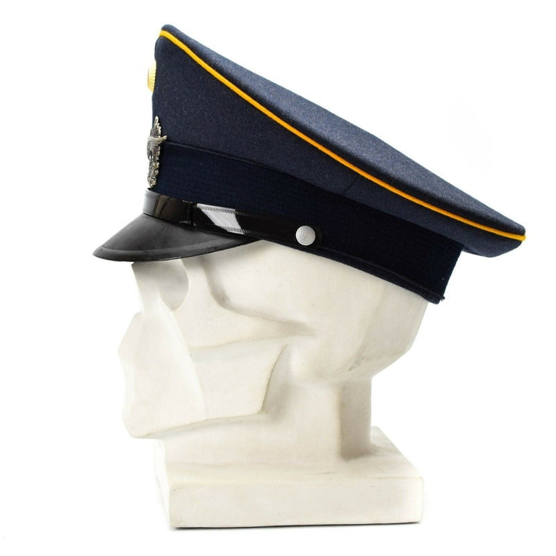 Vintage German Luftwaffe Air Forces peaked visor cap in blue with insignia on mannequin head display.