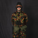 Person wearing genuine Italy military tanker goggles with camouflage uniform and helmet against black background