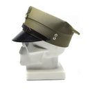 Original vintage Polish military olive peaked cap with black visor and eagle insignia on white display bust