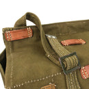 Close-up of genuine Romanian army bread bag made of olive canvas with leather details and metal buckle