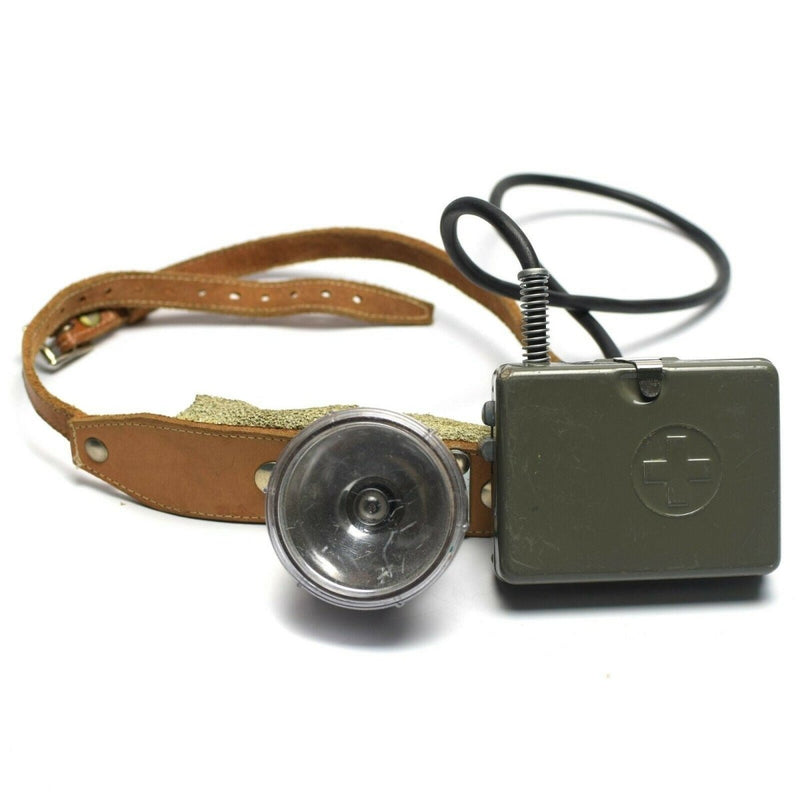 Vintage Swiss army military headlamp with leather strap and metal flashlight box from Cold War era Switzerland