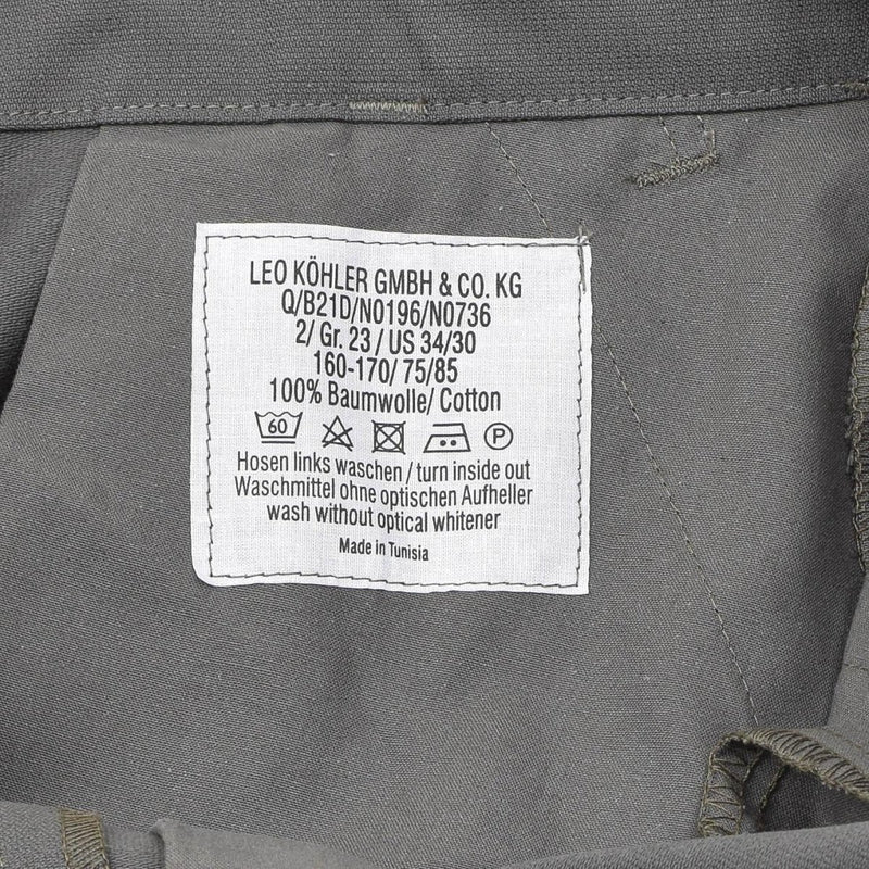 Care label on Leo Kohler gray cotton military cargo trousers with washing and care instructions shown