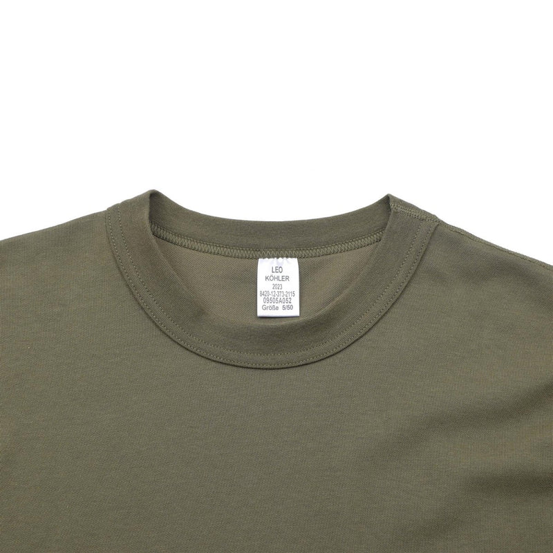 Close-up of olive green Leo Kohler tactical military short sleeve undershirt with crew neckline and tag visible