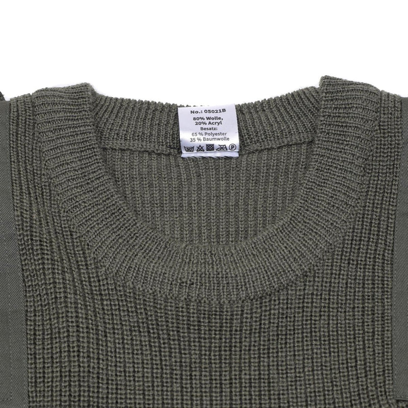 Close-up of a green sweater with a brand label on a white background