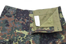 Mil-Tec German army style Flecktarn camo cargo pants with button waist and zip fly, partially unzipped to show interior lining.