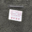 Close-up of olive green faux fur lining with care label inside MIL-TEC German military style parka jacket.