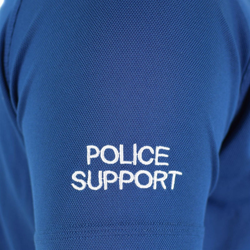 Close-up of blue breathable police support t-shirt sleeve with white embroidered text on fabric texture