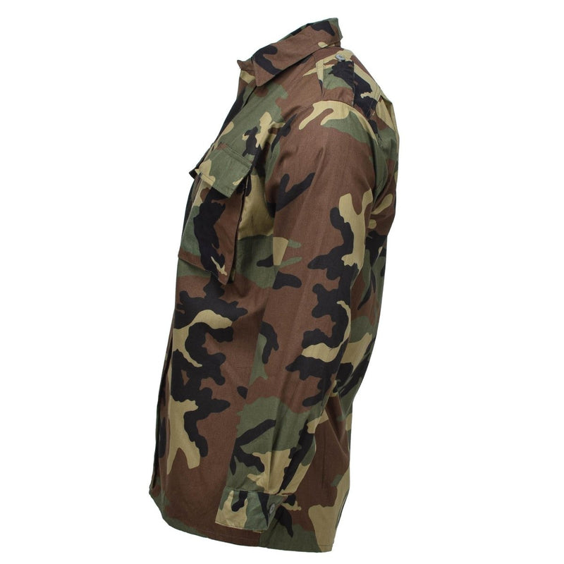 Croatian military issue cotton BDU shirt in woodland camo with long sleeves and multiple utility pockets side view