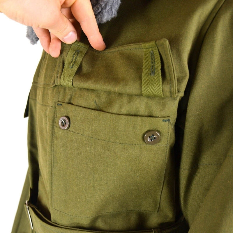 Close-up of olive green Czech army M85 parka pocket with button closures and durable fabric detail.