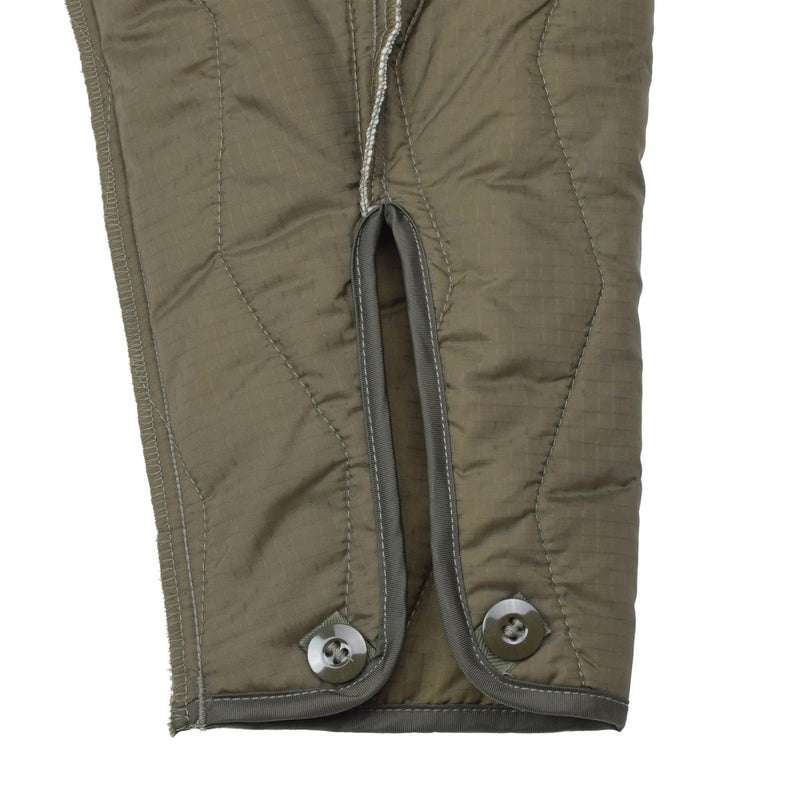 Close-up of olive quilted liner with buttoned cuffs for German military winter coverall jumpsuit lining