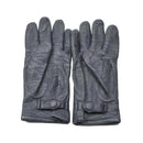 Pair of original German military surplus black leather gloves with adjustable wrist straps on white background