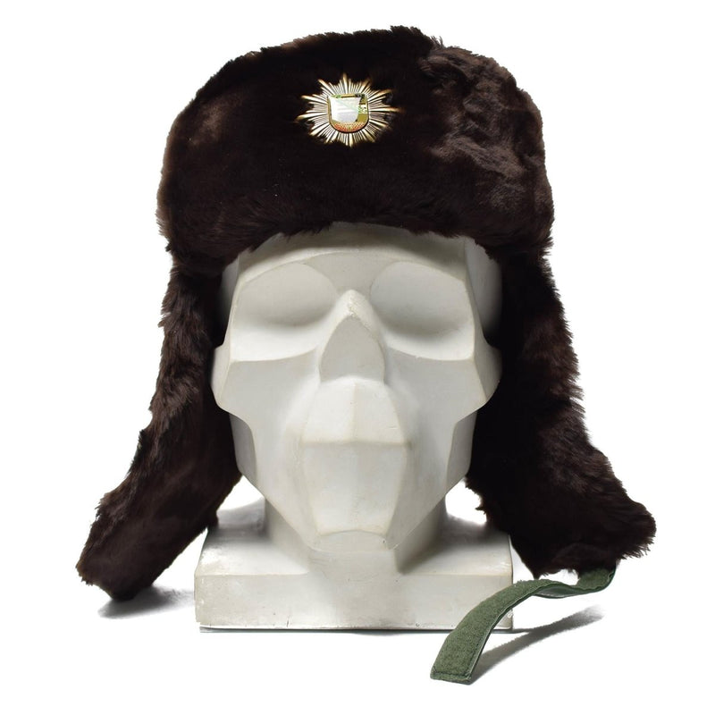 Original German police ushanka winter hat with faux fur lining, ear flaps, and cocarde badge for cold weather warmth.