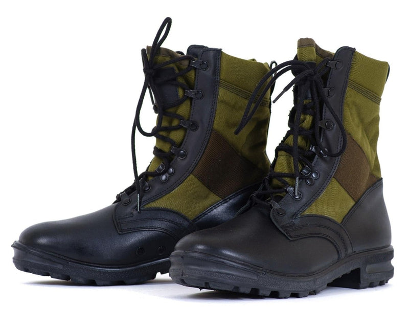 Pair of black and OD green Bates side zip military boots with laces and rugged soles on white background