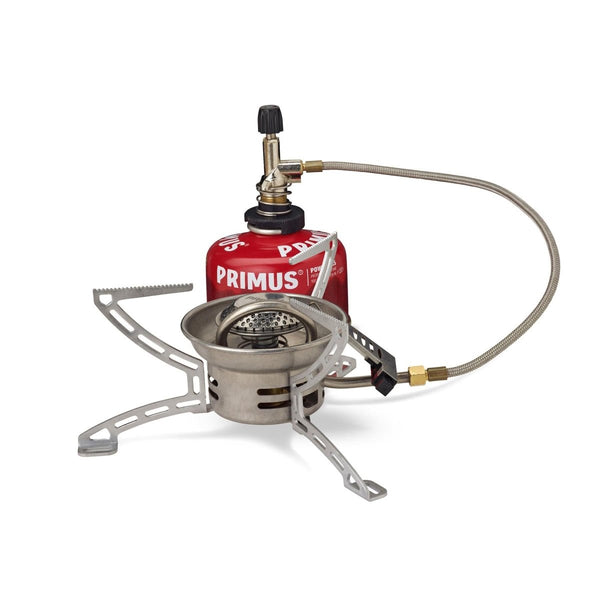 Compact Primus EasyFuel Duo foldable propane and butane camping stove with remote canister and foldable legs for outdoor cooking.