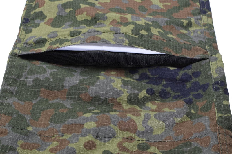 Close-up of flecktarn camo ripstop fabric with a zippered pocket on German Army style cargo pants