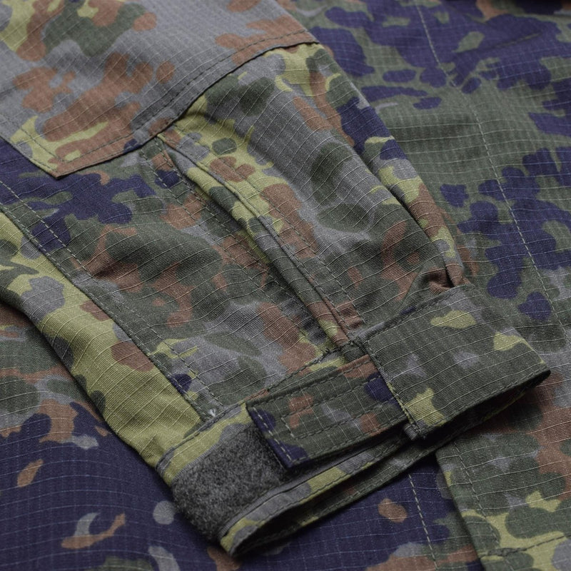 Close-up of TACGEAR Flecktarn camo jacket sleeve with ripstop fabric and adjustable cuff detail.