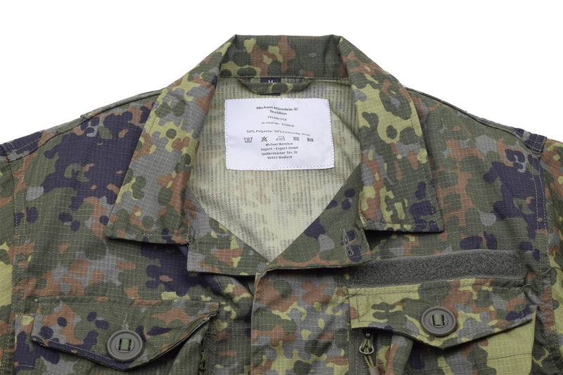 Close-up of TACGEAR Flecktarn camo jacket with ripstop fabric, buttoned pockets, and reinforced collar detail