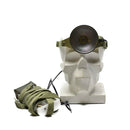 Skull with headlamp with green strap on a white background