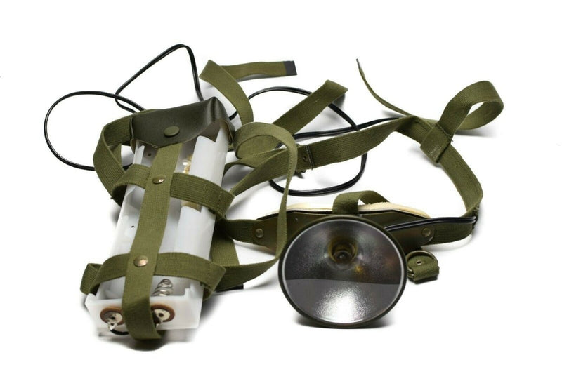 Green harness with cylindrical objects and a reflective disc on a white background